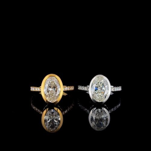 Oval bezel ring with diamond on band